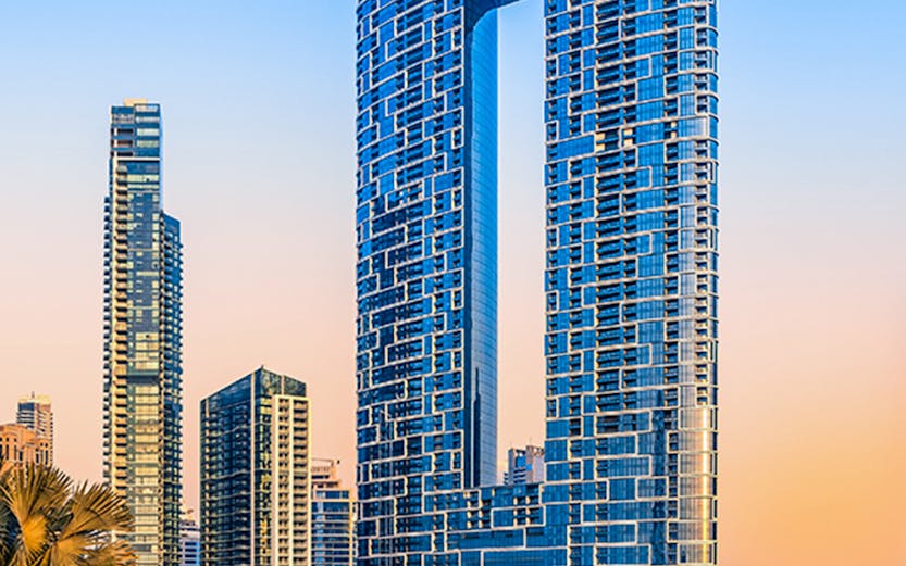 Jumeirah Beach Dubai skyline with modern skyscrapers at sunset.