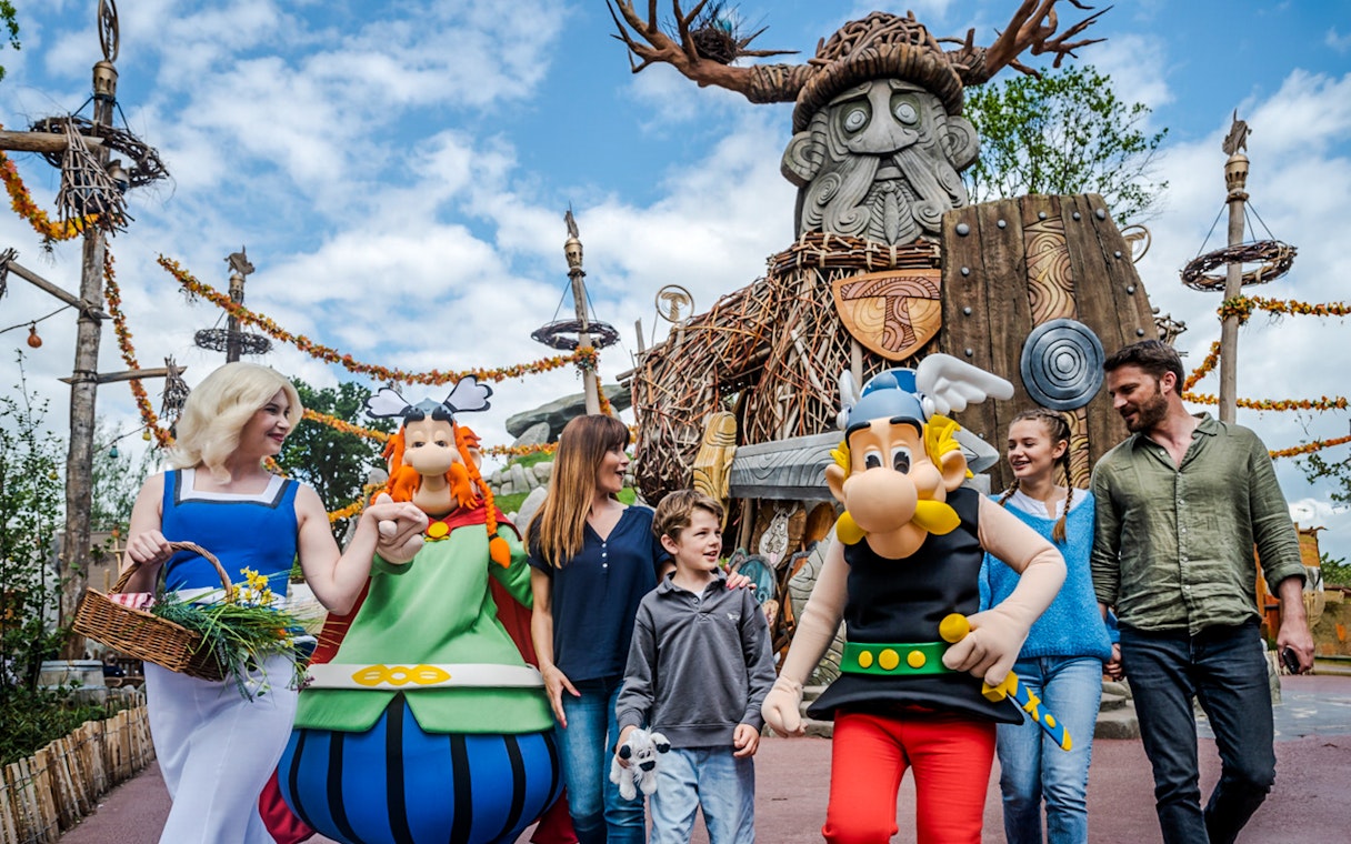 Characters from Parc Asterix in France entertaining tourists during a live show.
