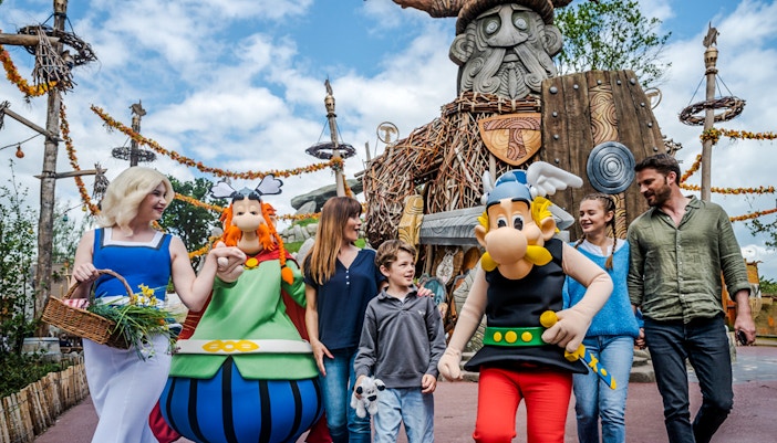 Visitors enjoying the Hydrolix ride at Parc Asterix, France, with vibrant themed surroundings.