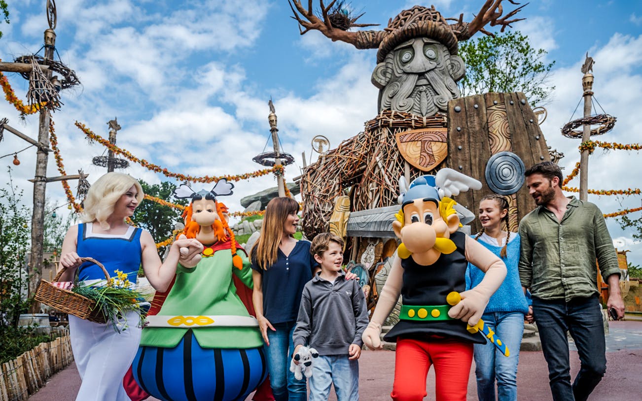 Characters from Parc Asterix in France entertaining tourists during a live show.