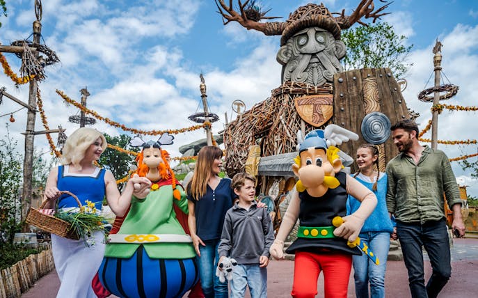 Characters from Parc Asterix in France entertaining tourists during a live show.