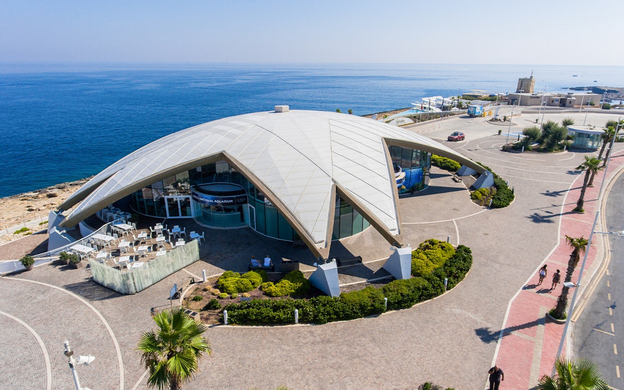 Aerial view of Malta National Aquarium with ocean backdrop.
