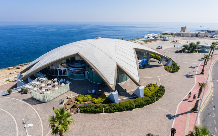 Aerial view of Malta National Aquarium with ocean backdrop.