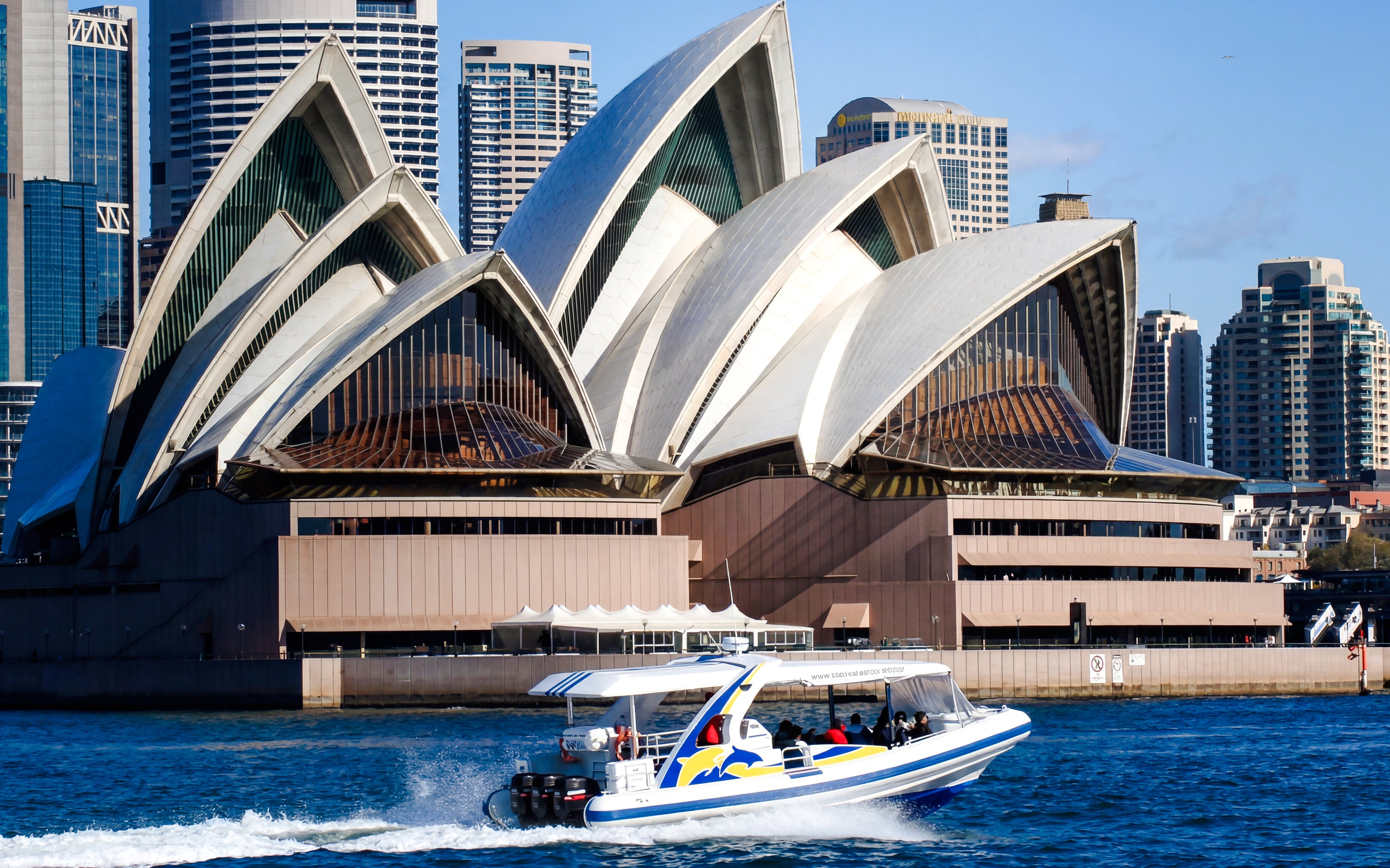 Whale watching boat near Sydney Opera House on a sunny day.