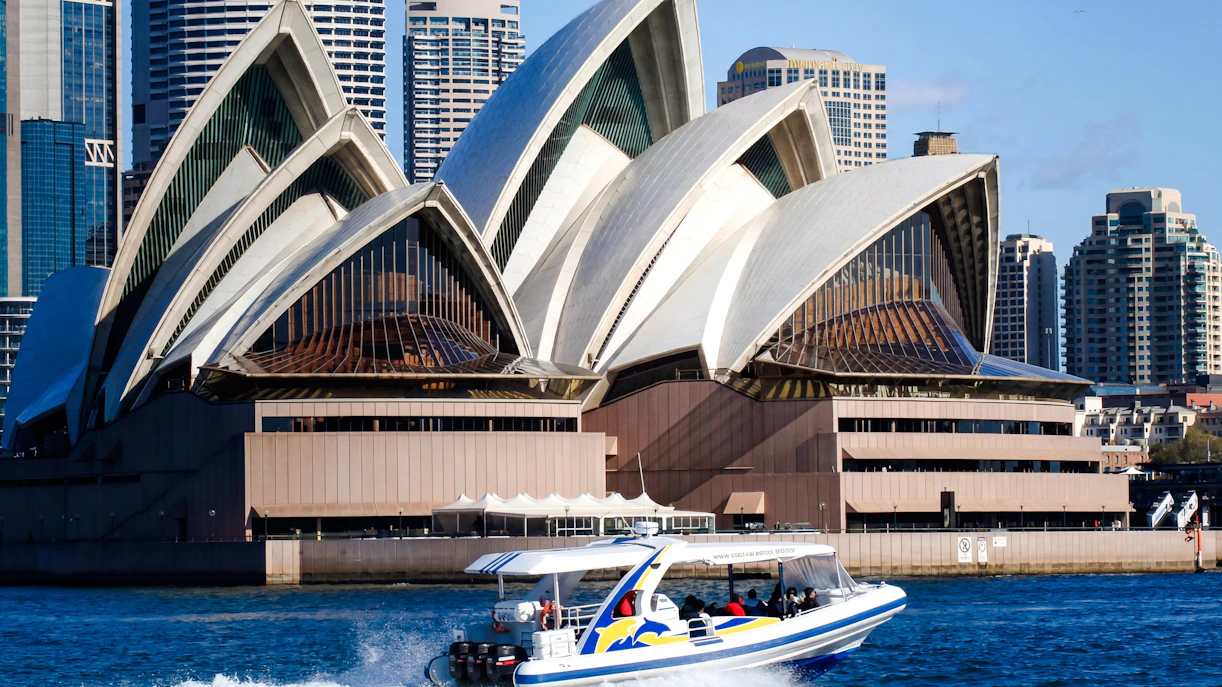 Whale watching boat near Sydney Opera House on a sunny day.
