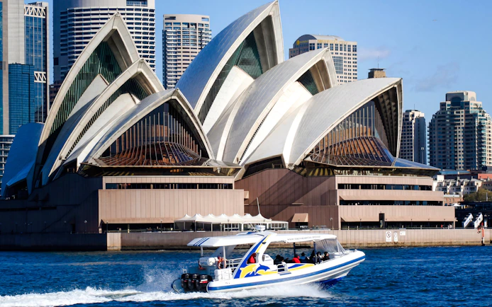 Whale watching boat near Sydney Opera House on a sunny day.