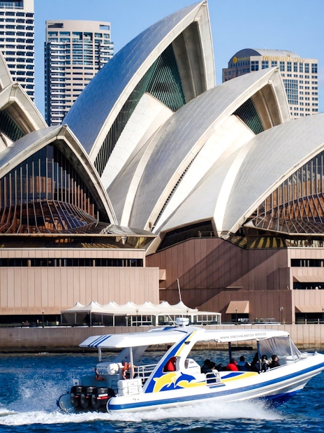 Whale watching boat near Sydney Opera House on a sunny day.