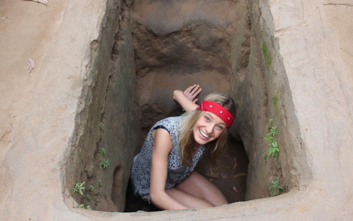 Visitor exploring Cu Chi Tunnels entrance during VIP PREMIUM speed boat tour.