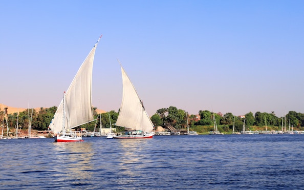 Traditional felucca sailing on the Nile River in Cairo, Egypt.