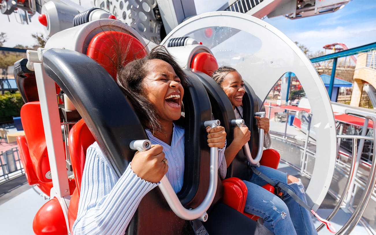 Visitors enjoying CYBORG™ Cyber Revolution ride at Six Flags Fiesta Texas.