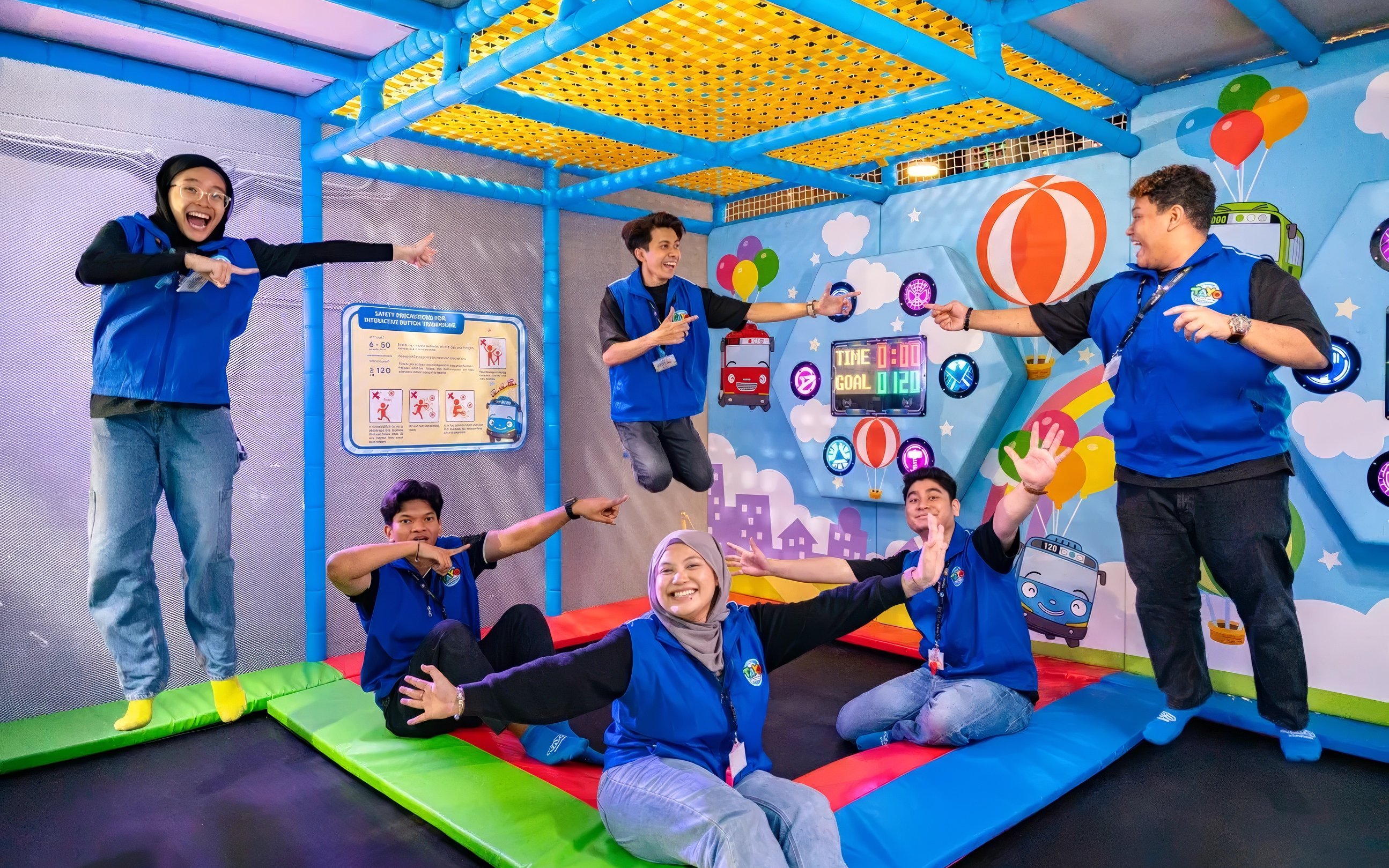 Adults enjoying activities at Tayo Station indoor playground.