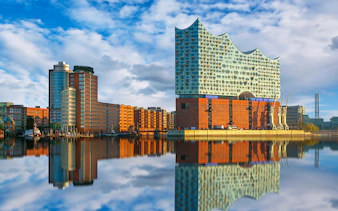 Elbphilharmonie concert hall reflecting on the river in Hamburg, Germany.