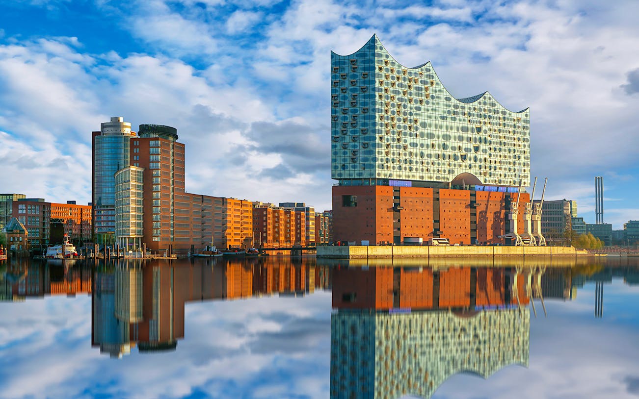 Elbphilharmonie concert hall reflecting on the river in Hamburg, Germany.