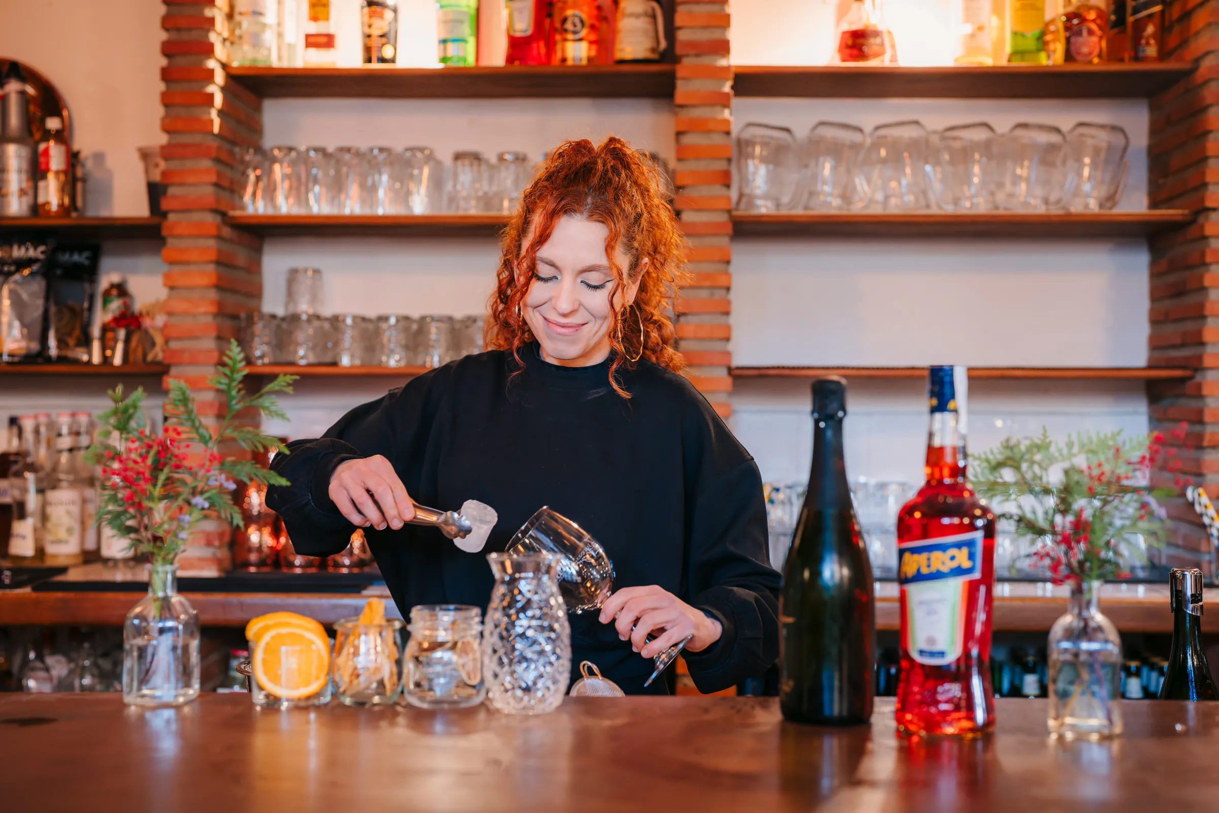 Bartender preparing a cocktail at Tablao Jardines de Zoraya bar in Granada.