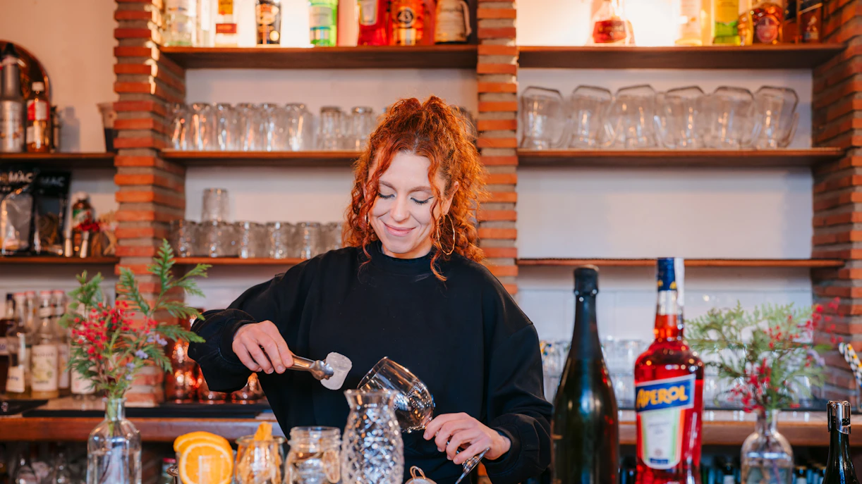 Bartender preparing a cocktail at Tablao Jardines de Zoraya bar in Granada.
