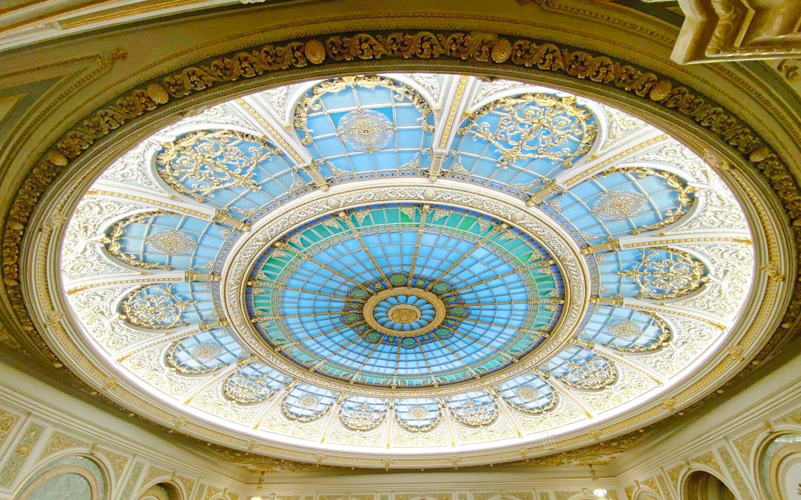 Ornate stained glass dome inside Parliament of Romania.