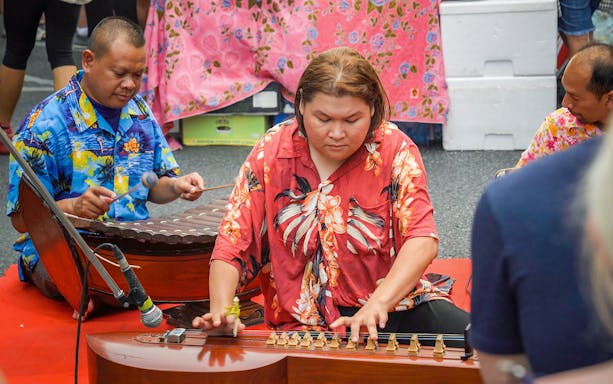 Musicians playing traditional instruments during a cultural performance in Phuket.