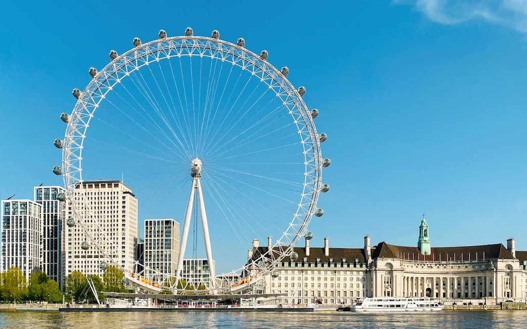 London Eye and River Thames on a sunny day, part of BigBus London tour.