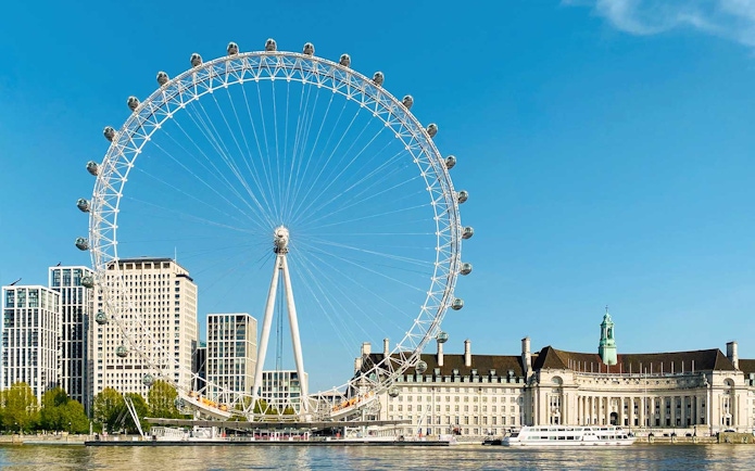 London Eye and River Thames on a sunny day, part of BigBus London tour.