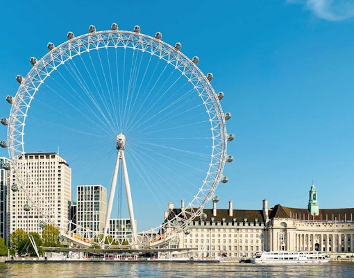 London Eye and River Thames on a sunny day, part of BigBus London tour.