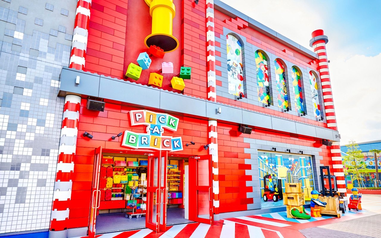 Pick-a-Brick store entrance at Legoland Japan's Bricktopia, featuring colorful LEGO bricks and figures.