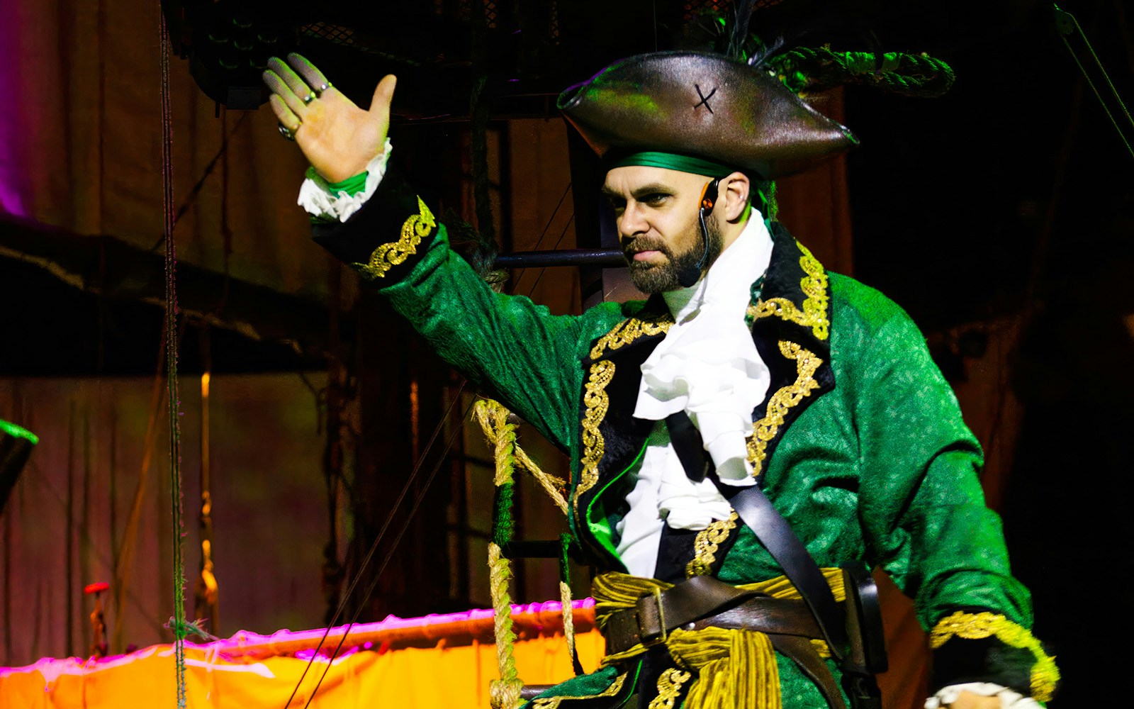 Pirate actor in green costume performing at Pirates Dinner Adventure Show.