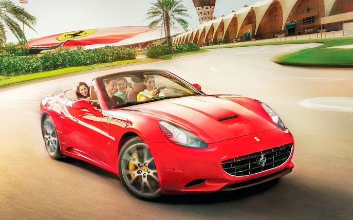 Ferrari driving experience at Ferrari World Abu Dhabi with passengers enjoying the ride.