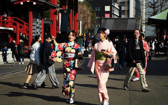 People in traditional kimonos walking near Senso-ji Temple in Asakusa, Tokyo.