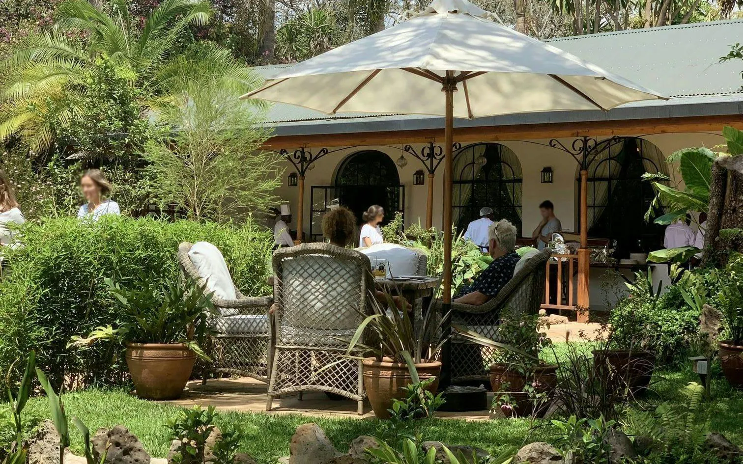 Visitors relaxing in the garden of Karen Blixen Museum, Nairobi, during the "Out of Africa" farm tour.