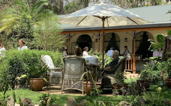 Visitors relaxing in the garden of Karen Blixen Museum, Nairobi, during the "Out of Africa" farm tour.