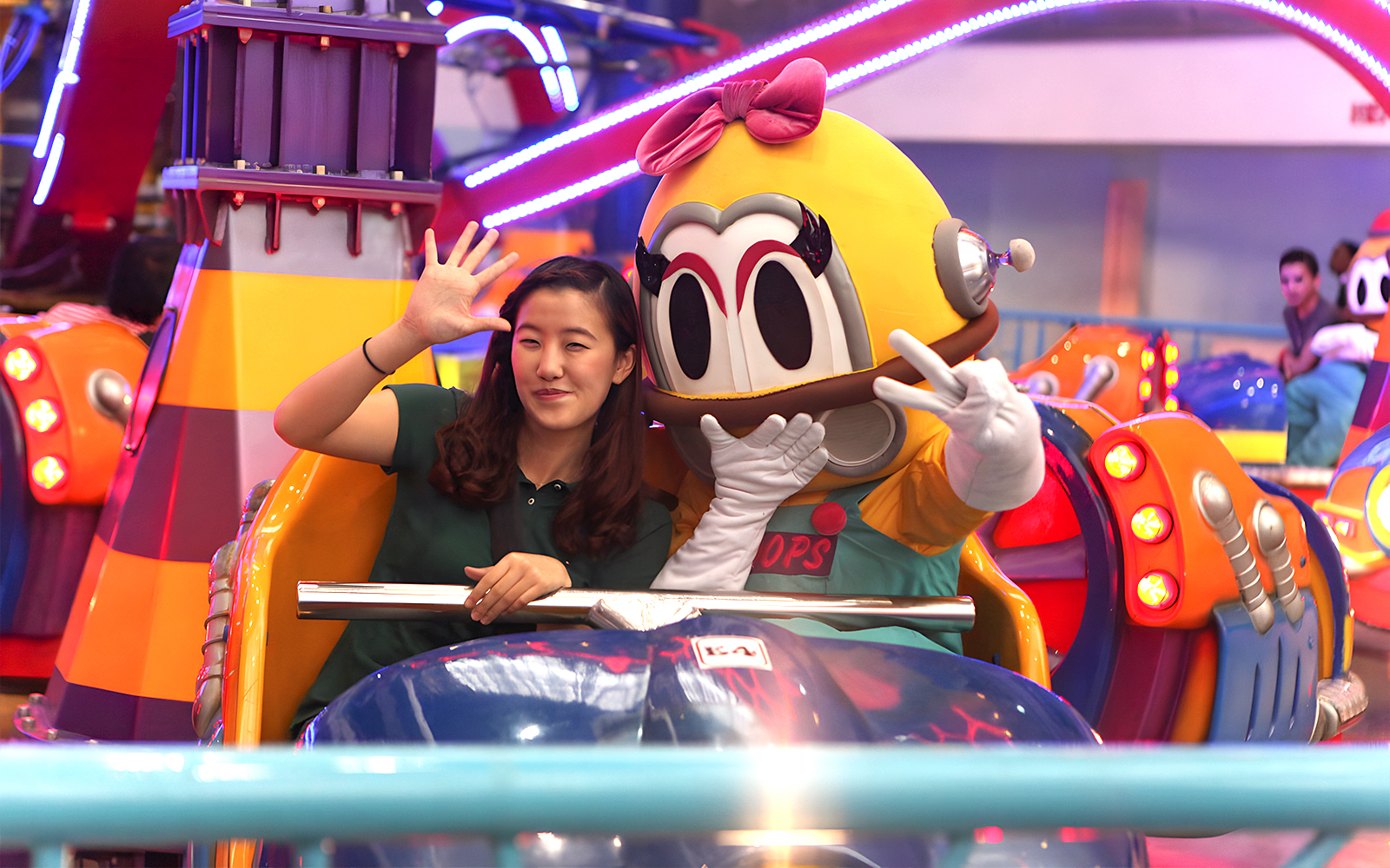 Person and mascot on a ride at Berjaya Times Square Theme Park, Kuala Lumpur.