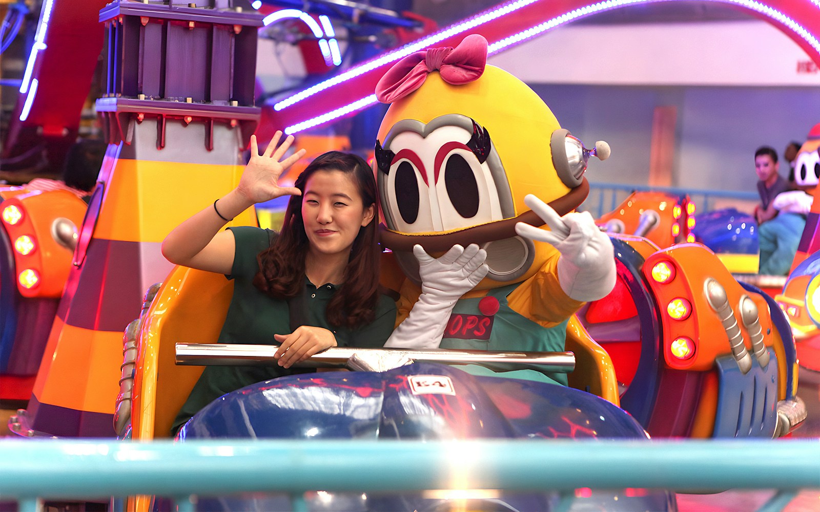 Person and mascot on a ride at Berjaya Times Square Theme Park, Kuala Lumpur.