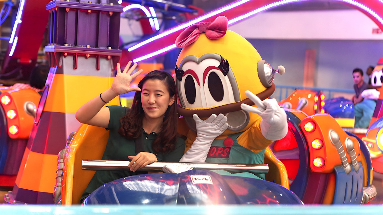 Person and mascot on a ride at Berjaya Times Square Theme Park, Kuala Lumpur.
