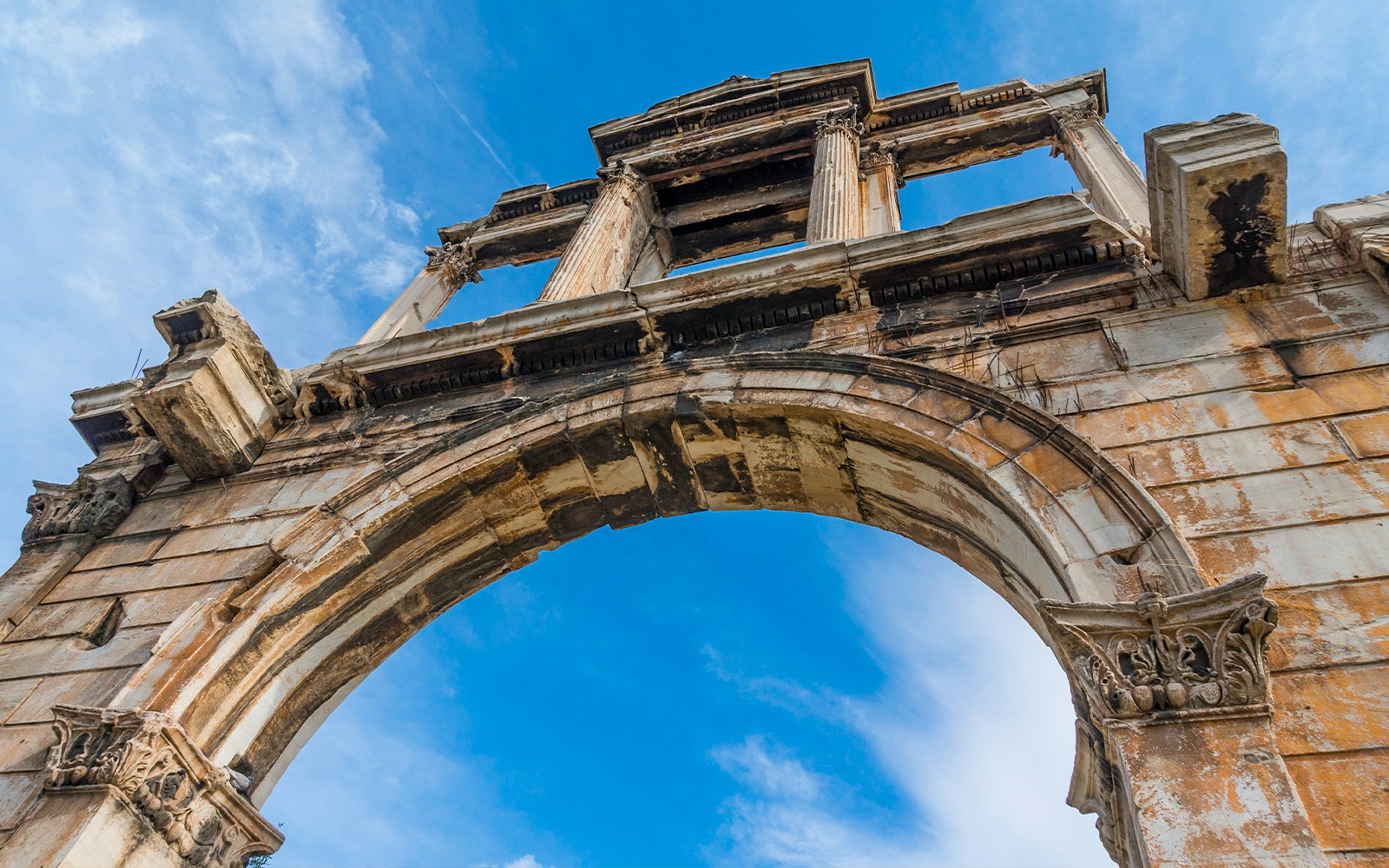 Hadrian’s Arch in Athens with blue sky background.