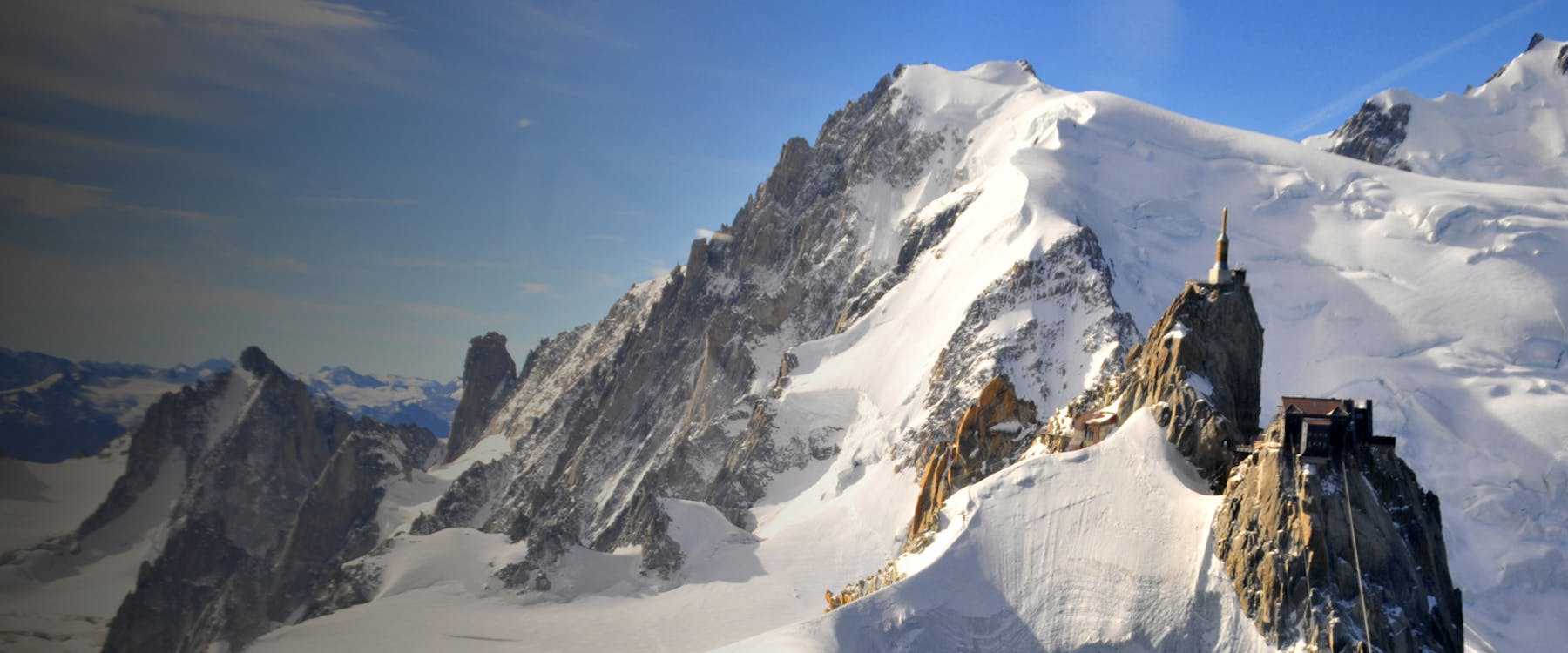 Aiguille du Midi peak with snow-covered mountains in Chamonix, France.