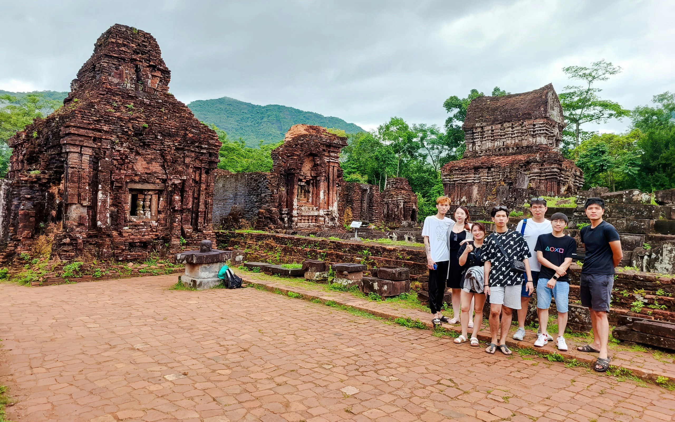 Group visiting ancient ruins at My Son Sanctuary, Vietnam.