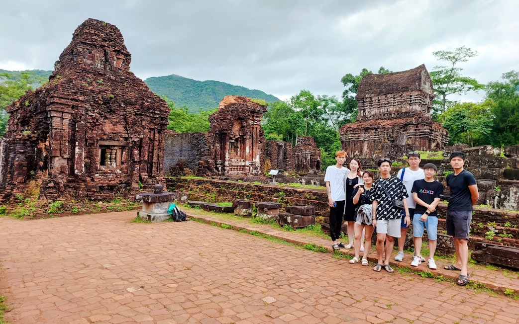 Group visiting ancient ruins at My Son Sanctuary, Vietnam.