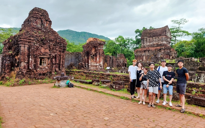 Group visiting ancient ruins at My Son Sanctuary, Vietnam.