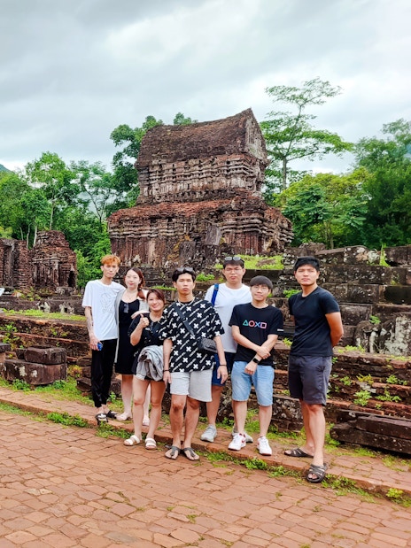 Group visiting ancient ruins at My Son Sanctuary, Vietnam.