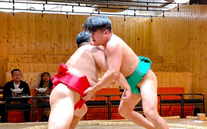 Sumo wrestlers competing in a traditional ring during a Sumo Show Experience.