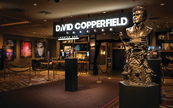 David Copperfield Theatre entrance with statue and illuminated sign.