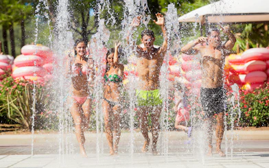 Visitors enjoying water jets at Chorros pool area, Western Water Park.