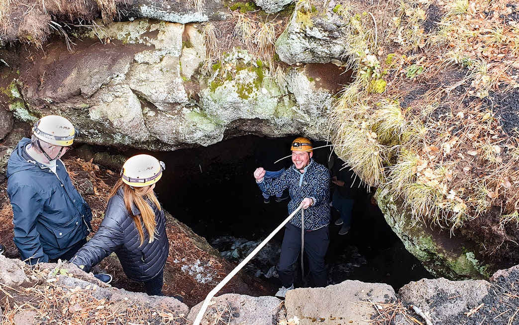 Tourists entering a cave during Mount Etna exploration tour.