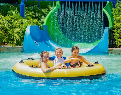 Visitors enjoying thrilling rides at ESCAPE Theme Park Penang, a popular tourist attraction in Malaysia