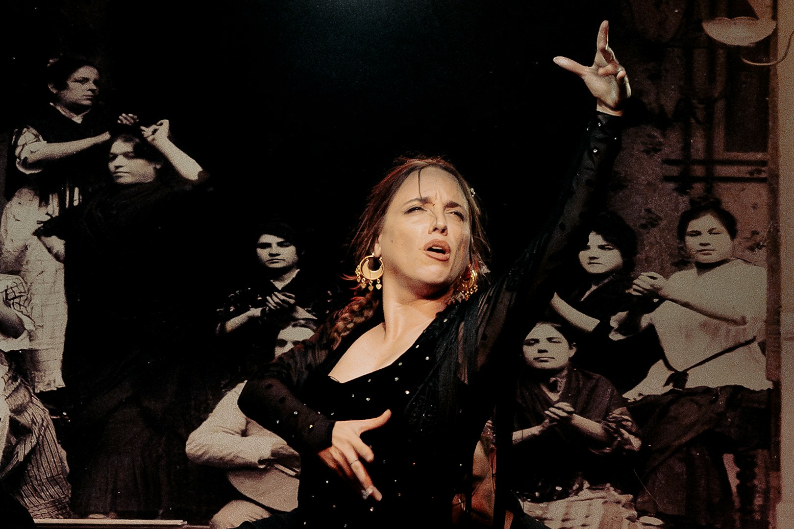 Flamenco dancer performing at Tablao La Cantaora with musicians in the background.