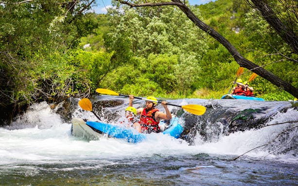 Canoe safari on a river near Split with participants navigating rapids.