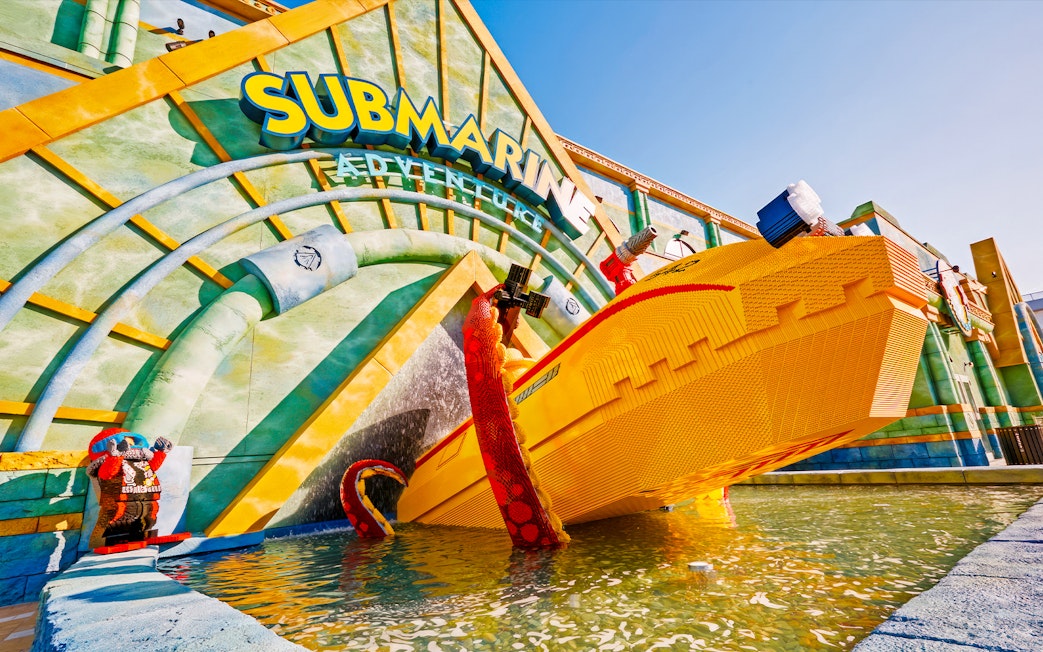 Submarine Adventure entrance at Legoland Japan with yellow Lego submarine and water feature.