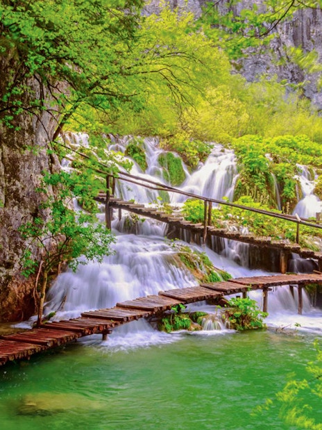Wooden path over waterfalls at Plitvice Lakes National Park, Croatia.