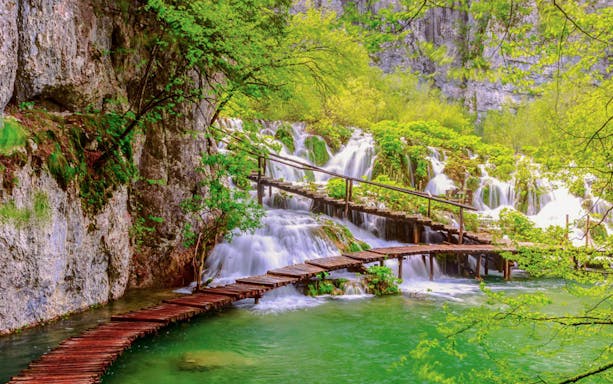 Wooden path over waterfalls at Plitvice Lakes National Park, Croatia.