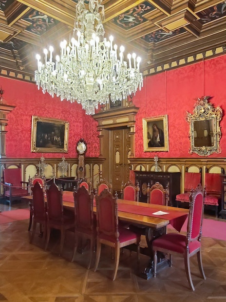 Miramare Castle Throne Room with chandelier and red furnishings in Trieste, Italy.